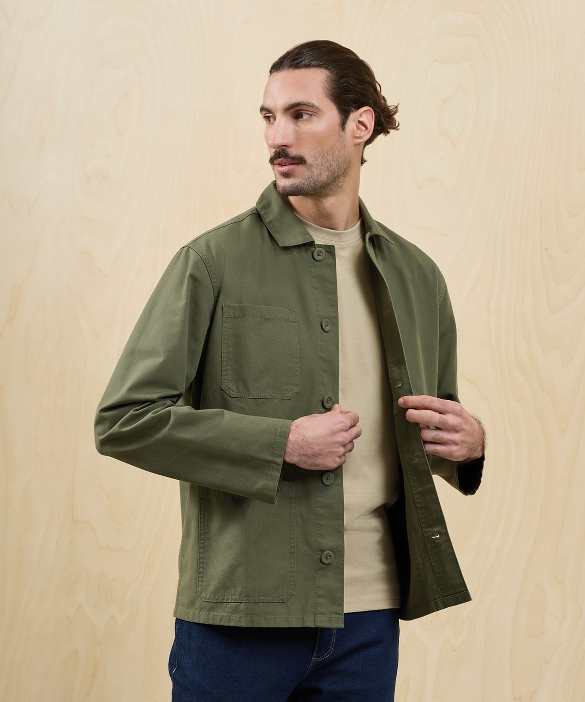 Adult model wearing an olive chore jacket